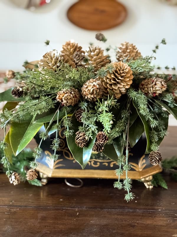 Christmas Table Centerpiece with Faux Greenery and Real Magnolia Leaves and bleached pinecones