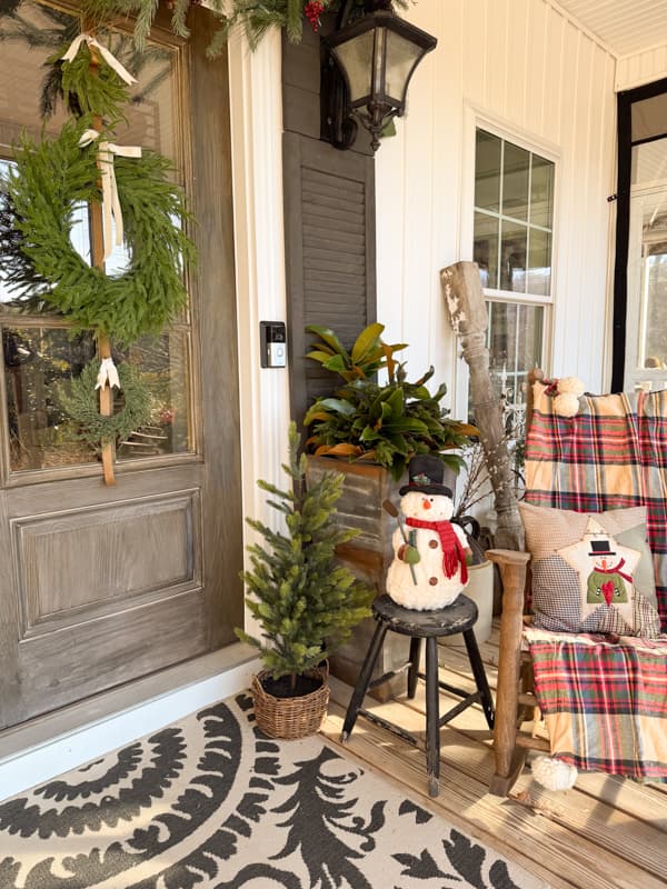 Planters, snowman and rocking chair by front door