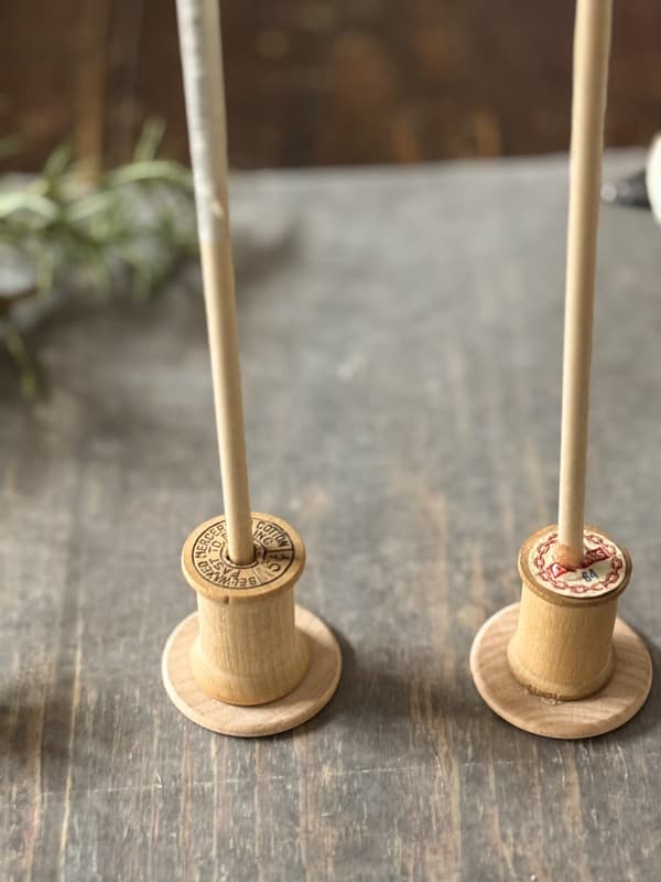 add dowel rod to thread spools with hot glue
