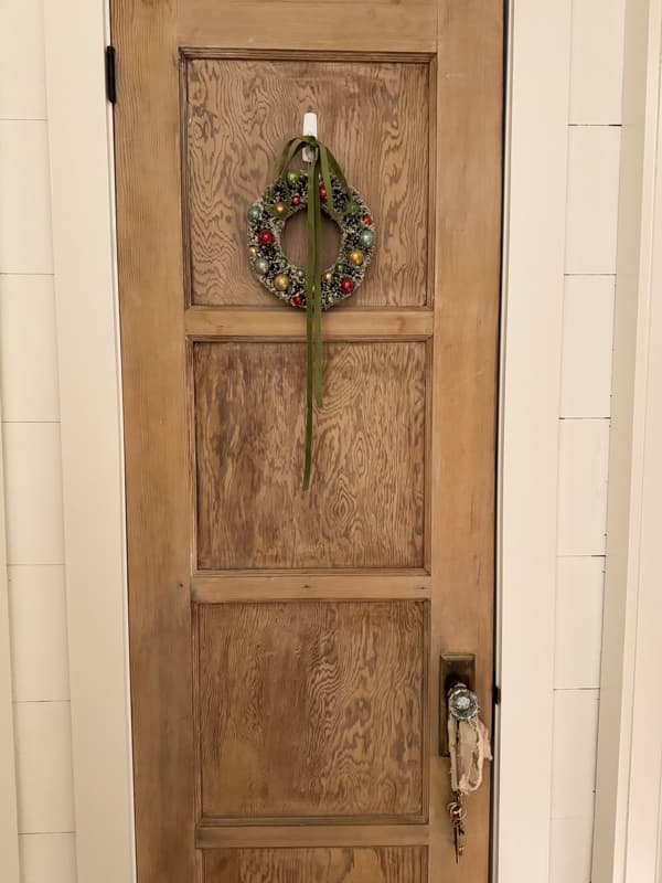 coat closet antique door with glass door knob and wreath