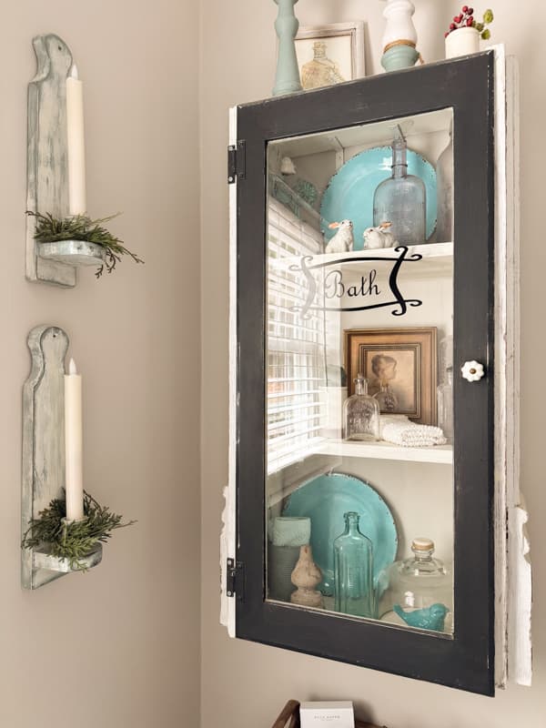 old cabinet door repurposed for a bathroom cabinet