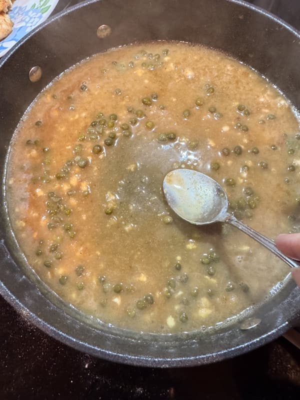 Chicken piccata sauce in skillet
