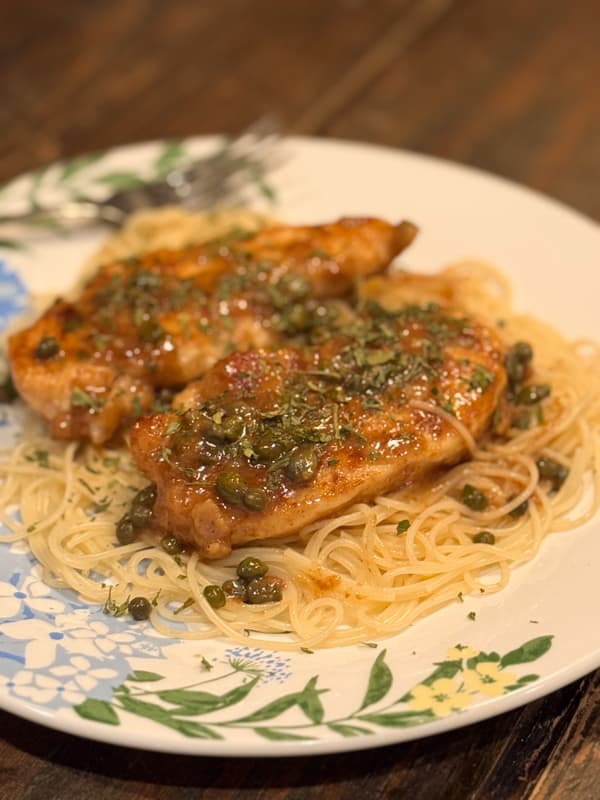Chicken Piccats on plate with angel hair pasta