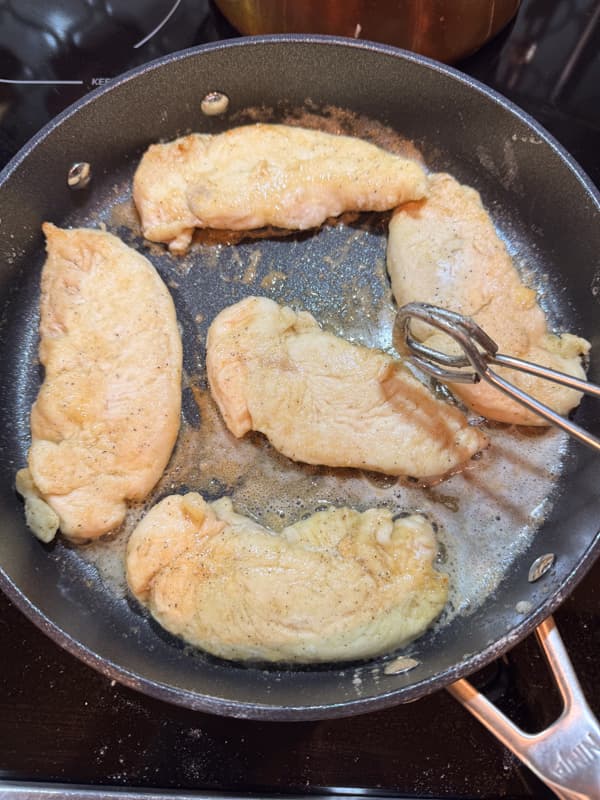 chicken tenders cooking in skillet