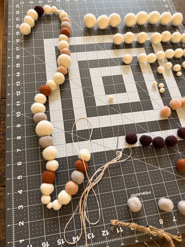 create a pattern for applying the felt balls to the cord