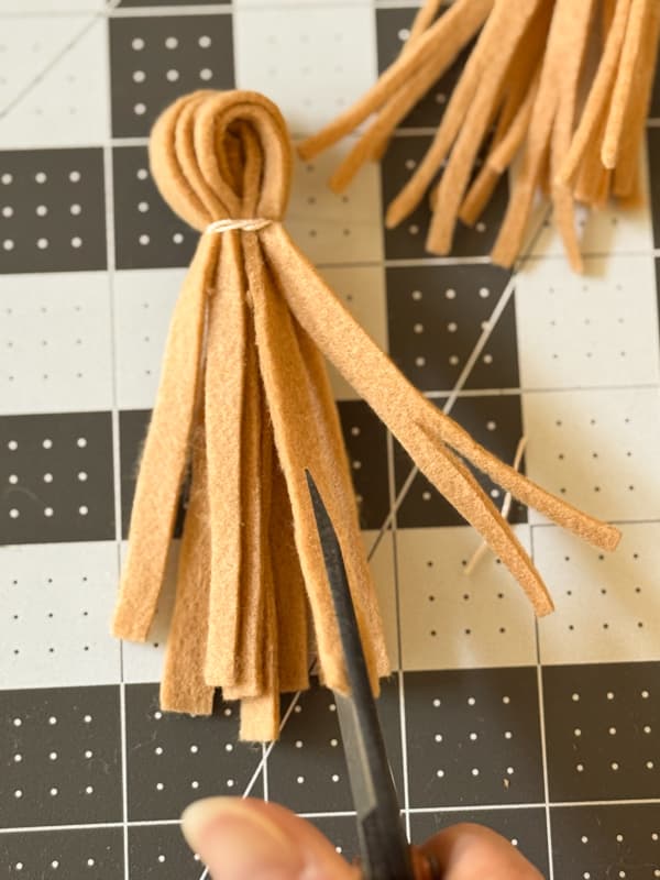 Cut eh felt tassel by spliting each end