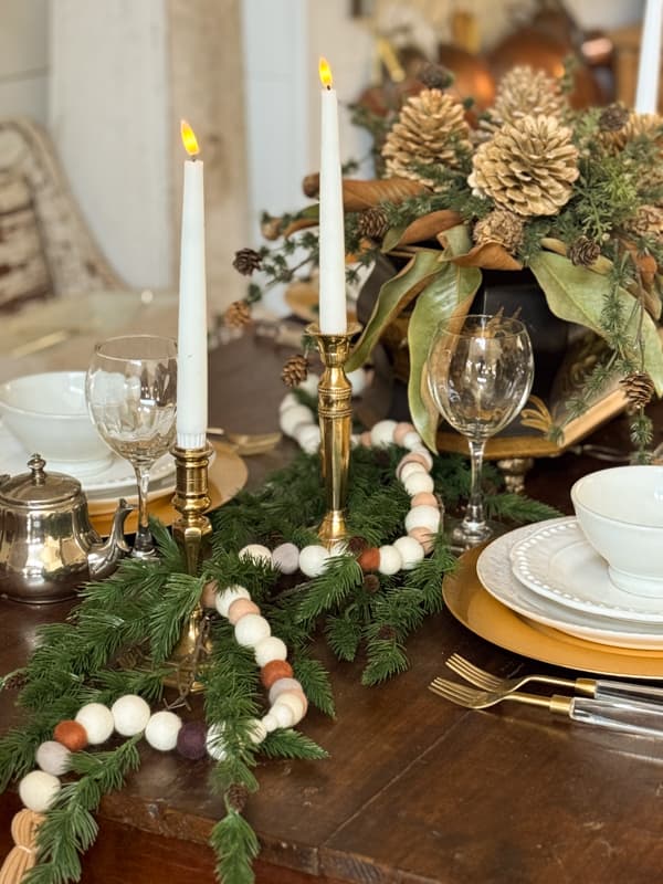 DIY Felt Ball Garland mixed with greenery for winter table runner