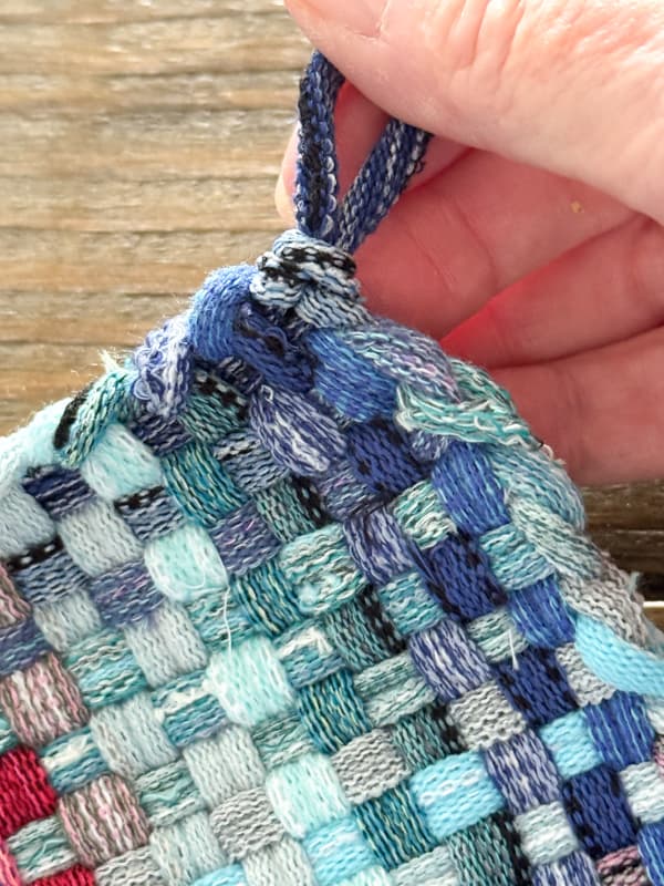 tie off to make the pot holder handle.