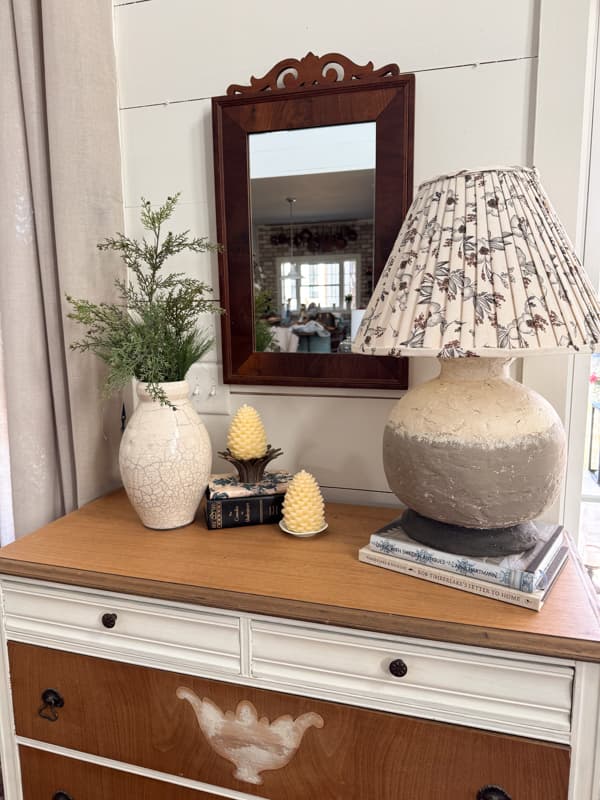 Entry table with DIY earthenware lamp and evergreens in pottery vase
