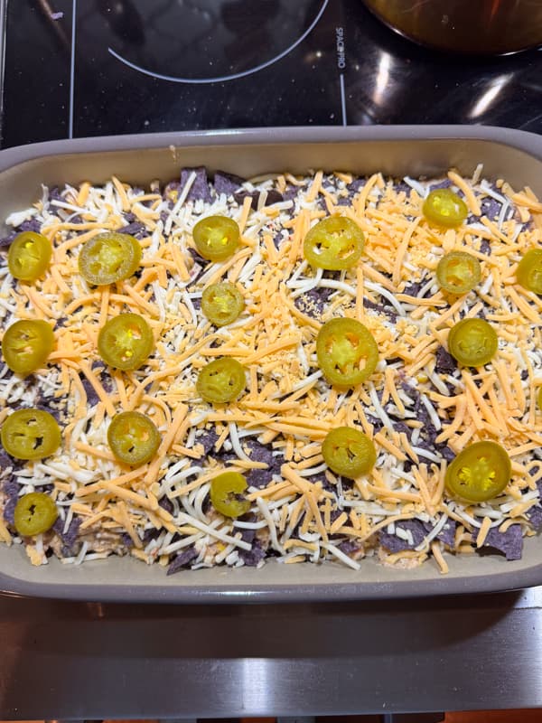 Mexican Chicken Casserole Ready for oven with jalepenos and cheese on top
