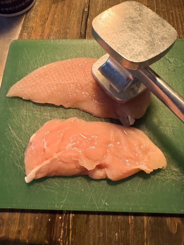 Pound the chicken breast on cutting board