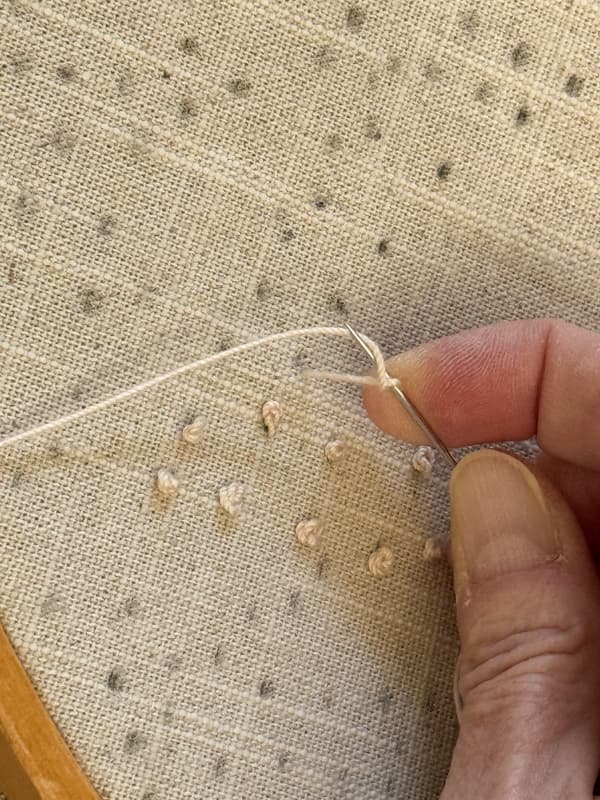 Wrap the tread around the needle forming a figure 8 