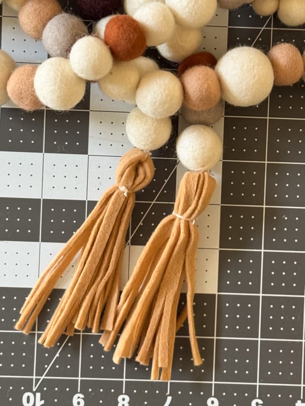 Attach the felt tassels to the ends of the DIY Felt Ball Garland