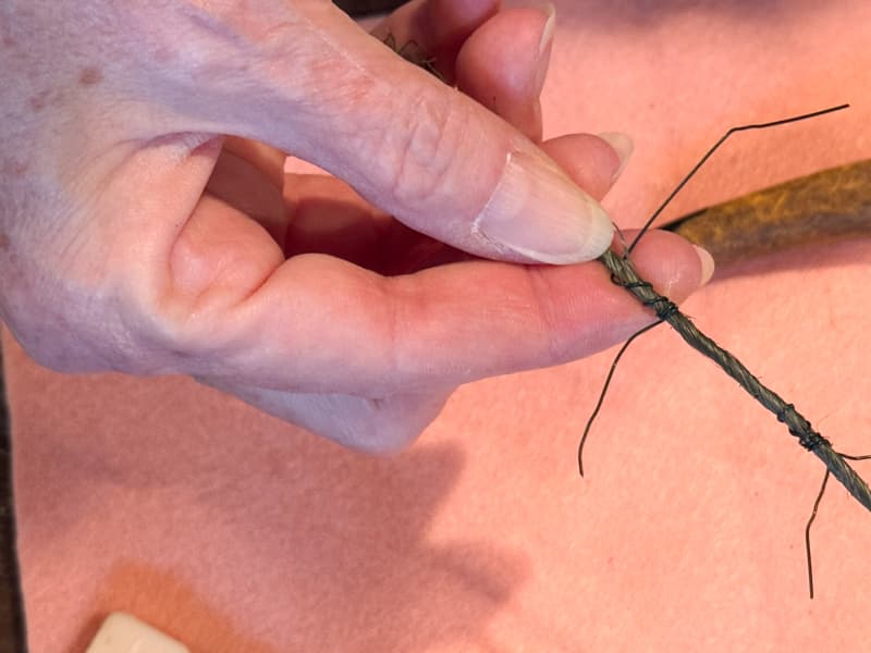 attaching the floral wire to the covered wire to make holders for the felt heart.  