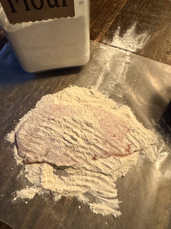 Coat chicken breast with flour mixture