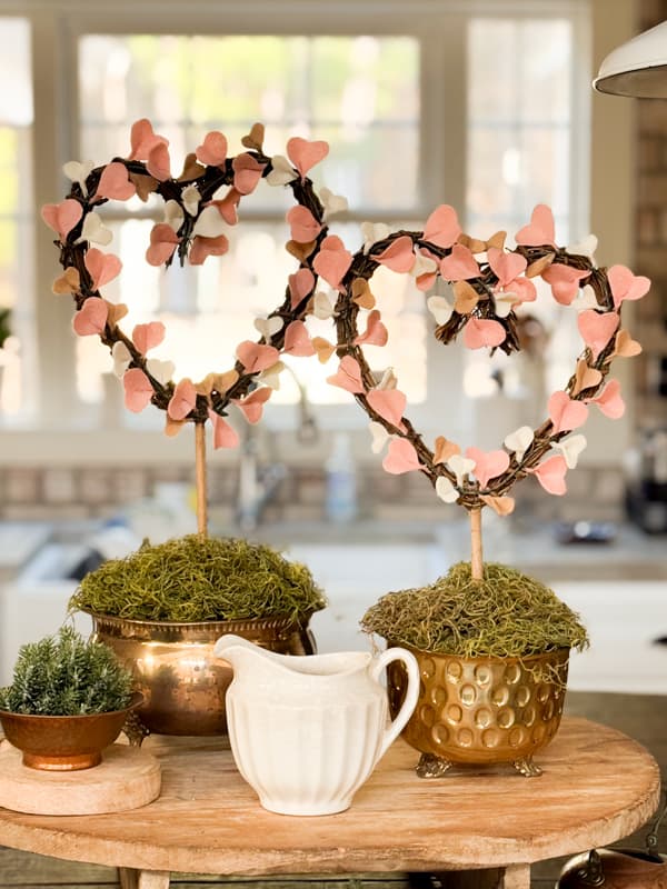 felt heart topiaries in brass containers on cheese board for the kitchen island centerpiece