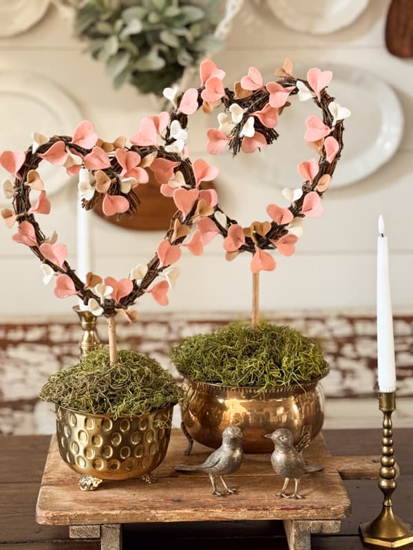 Felt Topiary Centerpiece on Dining Table with brass birds on a wooden table riser
