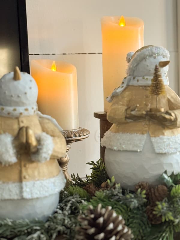 flicker pillar candles with snowmen on winter mantel