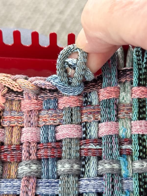 loop the ends though the previous loop to finish the edge of the pot holder