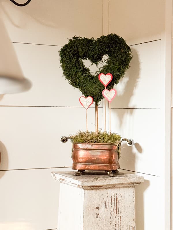 Moss heart topiary in copper container on vintage column