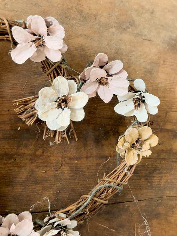 position wire on the frame for DIY Shabby Chic Pinecone Flower Wreath