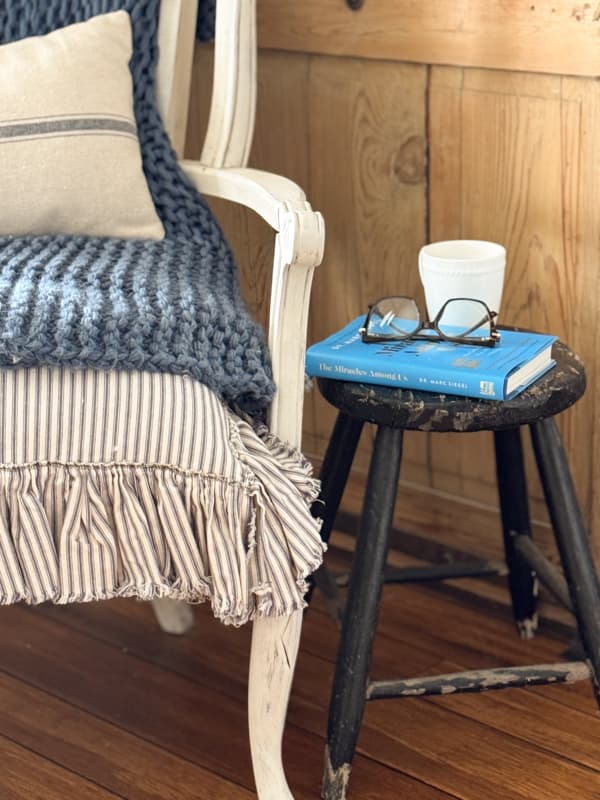 thrifted stool as side table for deconstructed chair