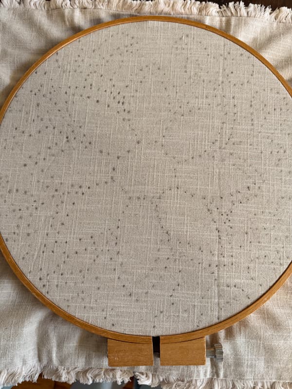 transferred design on pillow cover with embroidery hoop attached
