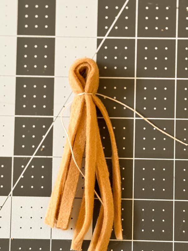 use cord to tie the tassel at the top