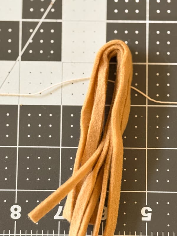 Use cord to tie the tassel at the top