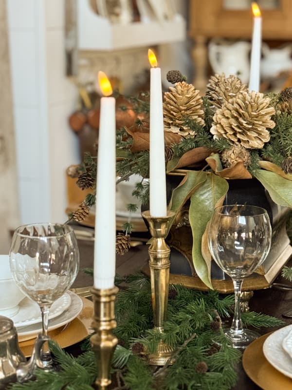 vintage brass candlestick and flicker candles on dining room table for winter