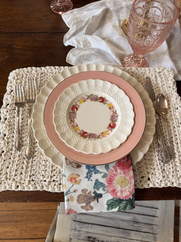 crochet placemat with silverware, dishes and napkin