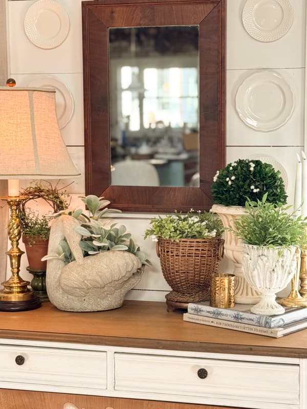 Spring Vignette with swan, planters, mirror and plates