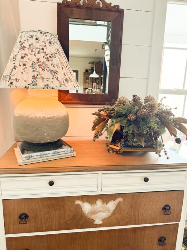 Large earthenware lamp on entry table with pinecone arrangement - statement lamp for modern heritage collected decorating style.  