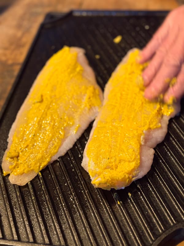 rub yellow mustard over catfish filets