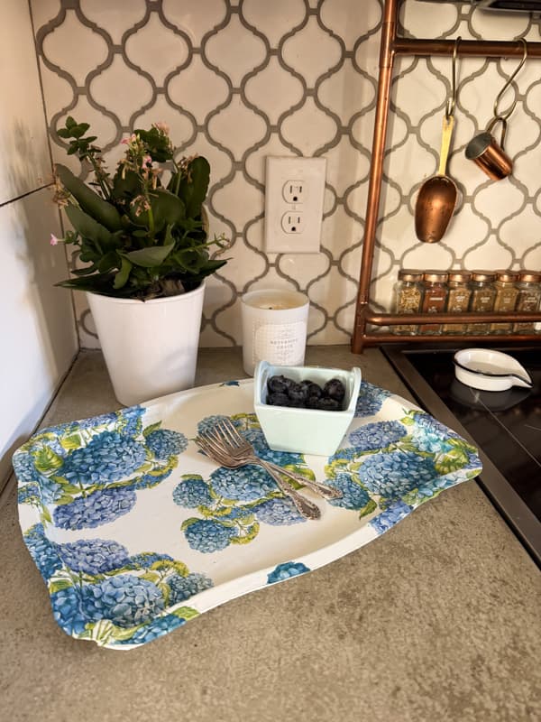 $3.00 Thrifted Silver Tray Makeover with hydranga napkins. Holding silverware and berries on kitchen countertop