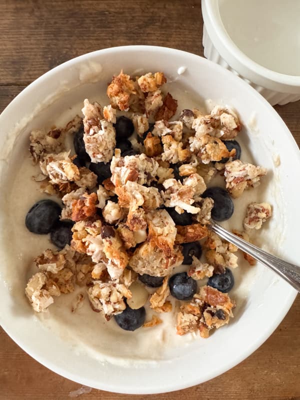 Yogurt Berries Granola for High Protein Breakfast in bowl with spoon