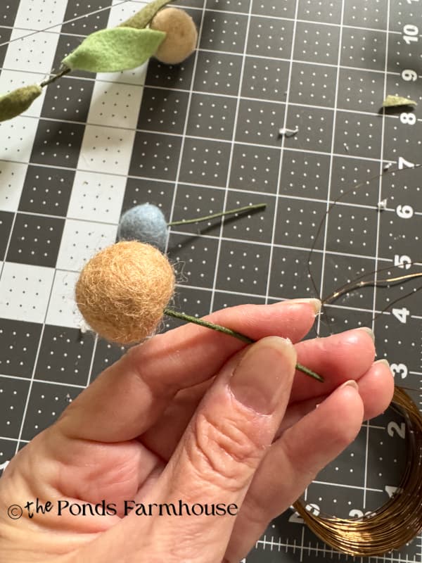insert floral wire stem into the hole in the felt ball