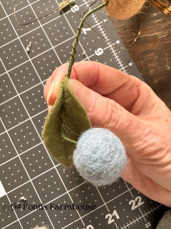 add felt leaves to the wire with hot glue