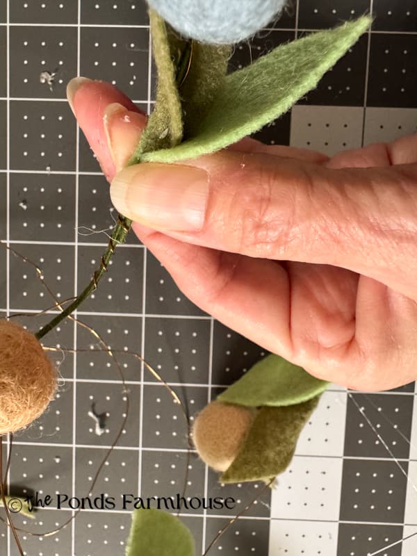 add felt leaves to the garland wire with hot glue