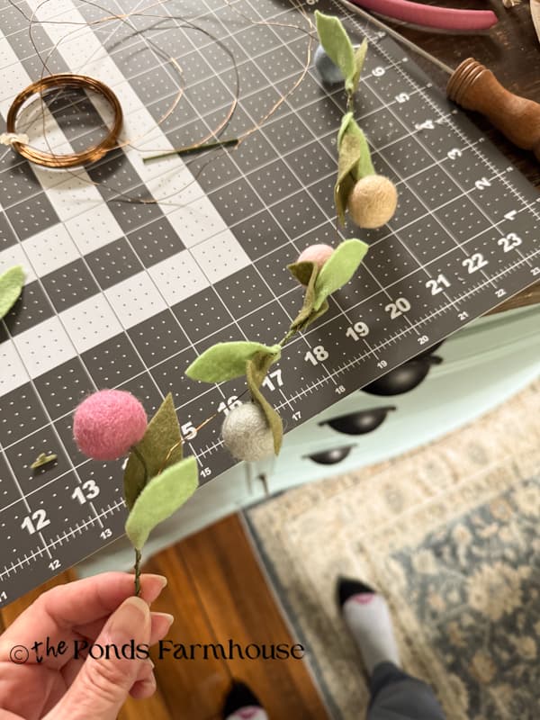 assemble the felt flowers along the wire to create a garland