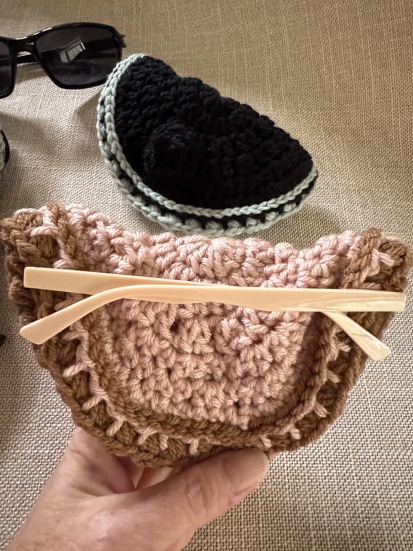 backside view of blush & brown sunglass holder with eyeglasses inside
