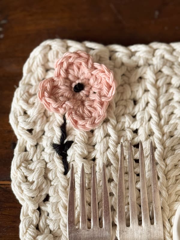 close up of crocheted blush flower to enhance the placemat