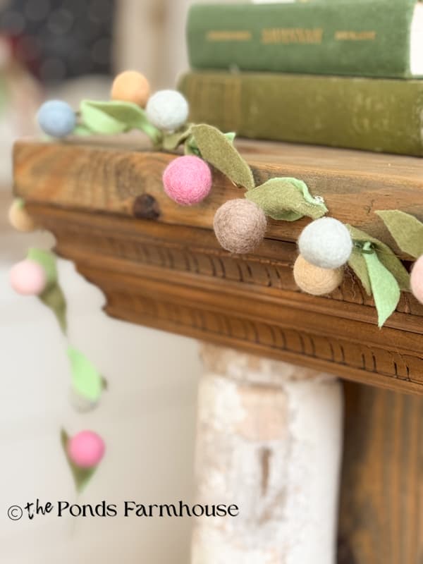close up view of felt flower spring garland on mantel