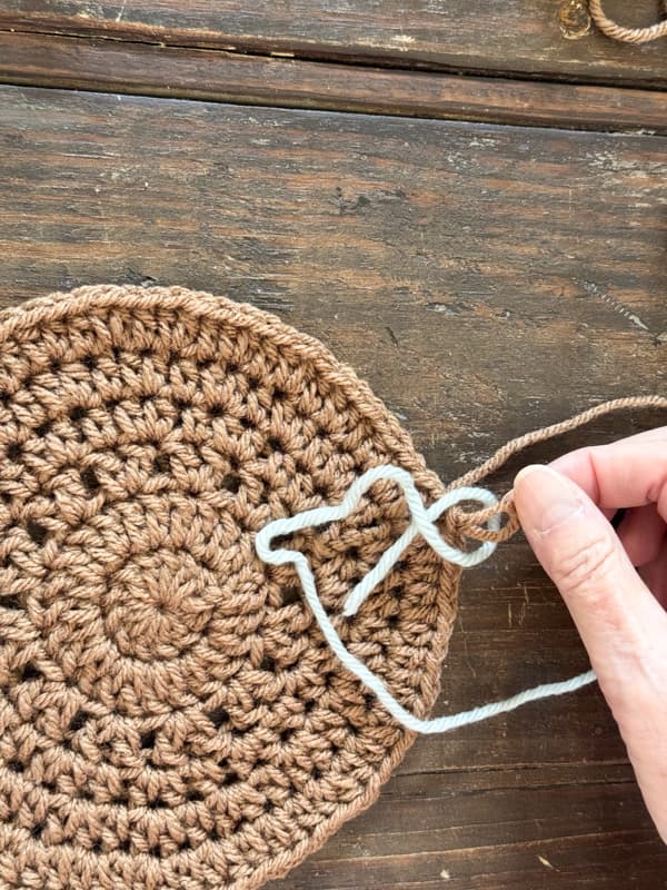 draw loop from previous yarn through the new yarn loop