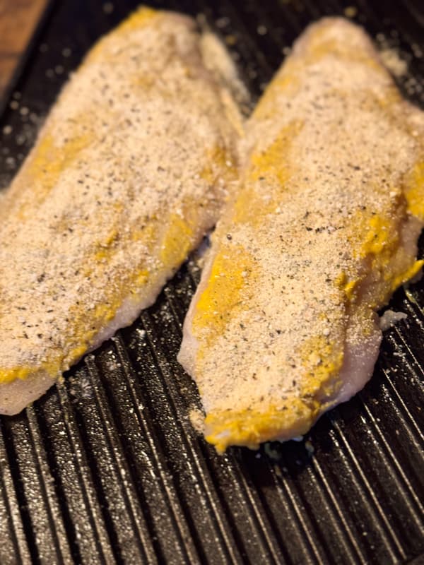 light coating of breadcrumbs over the mustard coated catfish.