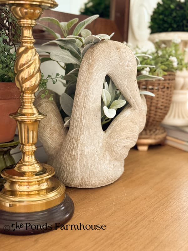 swan concrete planter with lambs ear stems and brass lamp