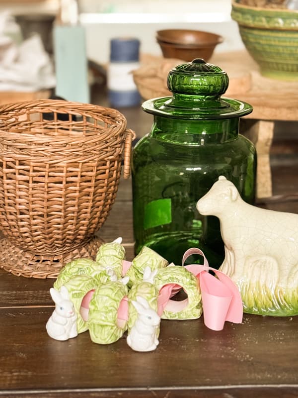 thrift store finds, bunny & cabbage nakpkin rings, wicker planter, green canister, and sheep figurine 