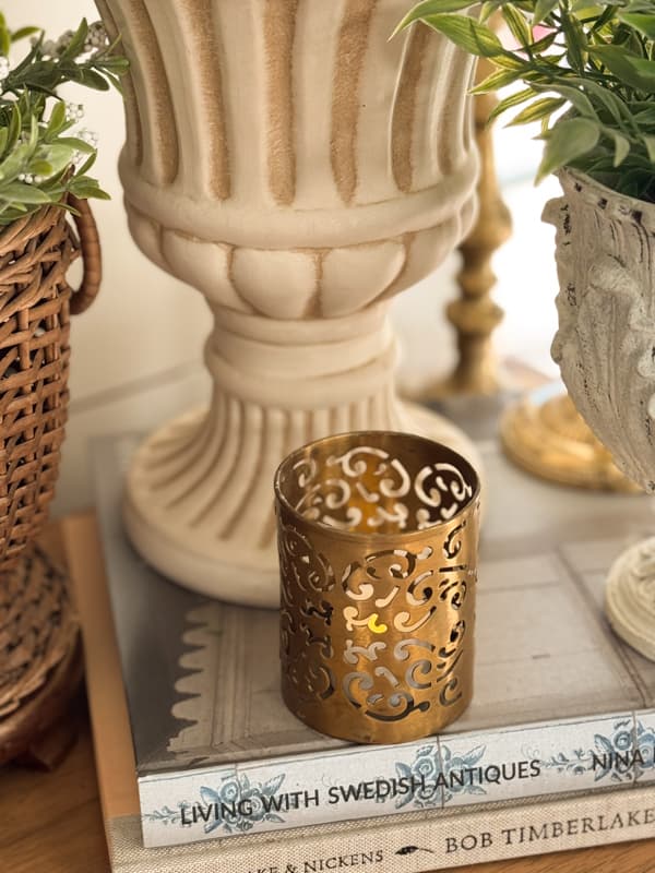 vintage brass candleholder on stack of books for Spring vignette