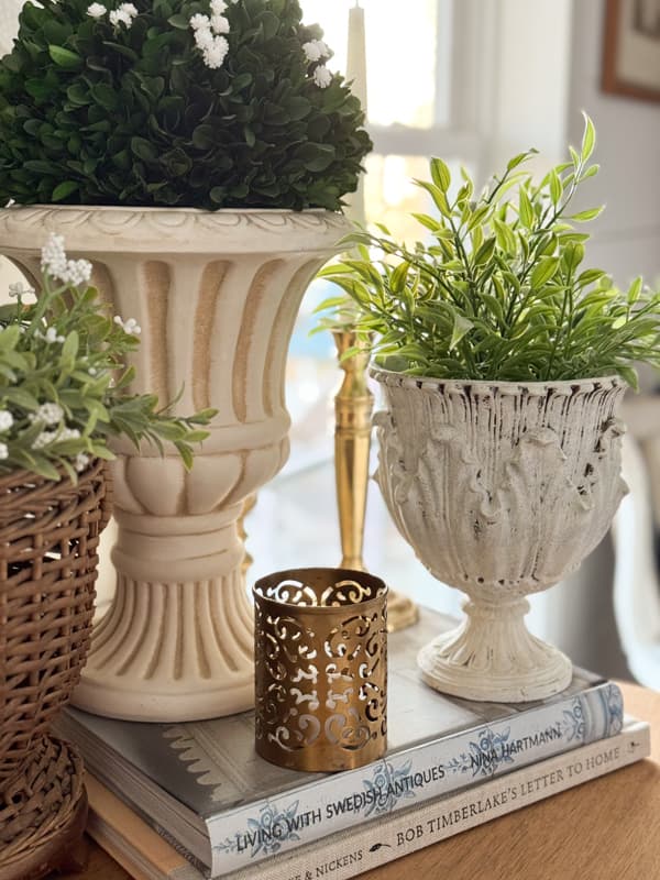 thrifted urns and planters with greenery for spring vignette