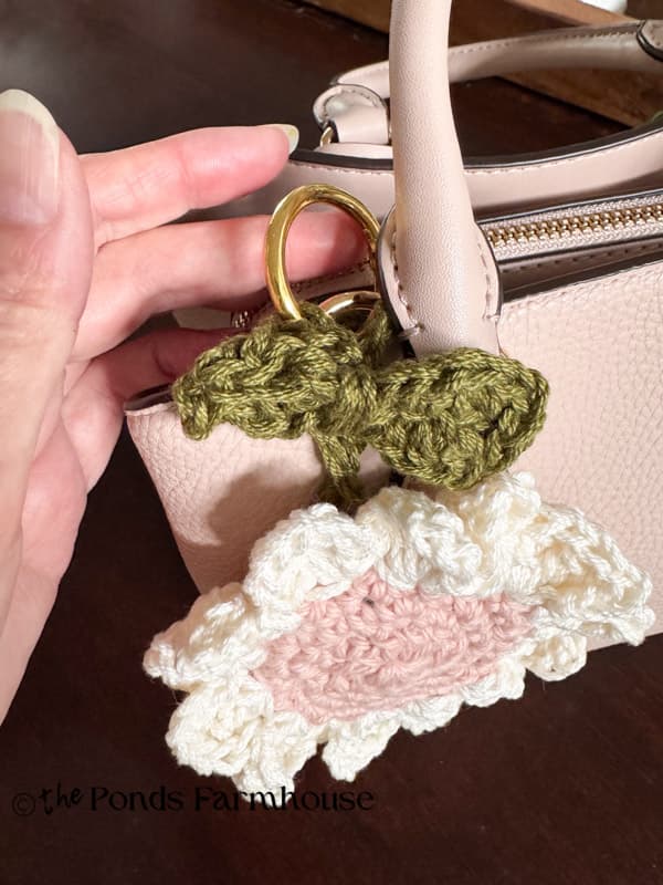 Adding purse charm to handle of handbag with key O ring